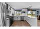 Eat-in kitchen includes stainless appliances, quartz countertops, and new white cabinetry at 1246 S Routt Way, Lakewood, CO 80232