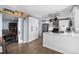 Kitchen featuring new cabinets, stainless appliances and bar-top counter overlooking dining room at 1246 S Routt Way, Lakewood, CO 80232