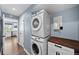Interior laundry area includes stacked washer/dryer and ample storage at 1246 S Routt Way, Lakewood, CO 80232