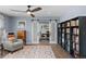 Open-concept living room featuring hardwood floors, sliding barn doors, and a cozy seating area at 1246 S Routt Way, Lakewood, CO 80232