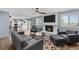Bright living room featuring a cozy fireplace, hardwood floors, and a view into the kitchen at 1246 S Routt Way, Lakewood, CO 80232