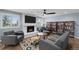 Bright living room featuring a cozy fireplace, hardwood floors, and custom built-in bookshelves at 1246 S Routt Way, Lakewood, CO 80232