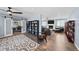 Open-concept living room featuring hardwood floors, sliding barn doors, and a cozy seating area at 1246 S Routt Way, Lakewood, CO 80232