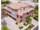 Aerial view showcasing multi-story townhome with a tile roof and attached garages at 3491 Cascina Pl # D, Highlands Ranch, CO 80126