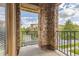 Balcony with brick pillars and iron railing offering views of the street and building at 3491 Cascina Pl # D, Highlands Ranch, CO 80126