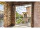 Balcony with brick pillars and iron railing, offering views of the street and neighborhood at 3491 Cascina Pl # D, Highlands Ranch, CO 80126