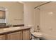 Bathroom features a single sink vanity and a tub/shower combination with white tiled walls at 3491 Cascina Pl # D, Highlands Ranch, CO 80126