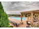 Stunning community pool with lounge chairs, pergolas and tables perfect for relaxing poolside at 3491 Cascina Pl # D, Highlands Ranch, CO 80126