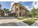 Lovely multi-story townhome with brick and stucco facade, two-car garage and professional landscaping at 3491 Cascina Pl # D, Highlands Ranch, CO 80126