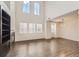 Spacious living room with soaring ceilings, large windows and hardwood floors at 3491 Cascina Pl # D, Highlands Ranch, CO 80126