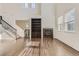 Bright and airy living room with hardwood floors, high ceilings, fireplace and staircase at 3491 Cascina Pl # D, Highlands Ranch, CO 80126