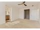 Bright primary bedroom with ceiling fan, carpet flooring, and access to the ensuite bathroom at 3491 Cascina Pl # D, Highlands Ranch, CO 80126