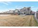 Large backyard featuring green grass and neighboring homes along the wood fence at 13563 E 106Th Pl, Commerce City, CO 80022