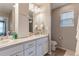 Bathroom featuring dual sinks, white cabinets, a large mirror, and modern fixtures at 13563 E 106Th Pl, Commerce City, CO 80022