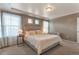 Bright bedroom featuring neutral walls, soft carpet, a padded headboard, and abundant natural light at 13563 E 106Th Pl, Commerce City, CO 80022
