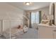 Bright bedroom featuring white frame bed, soft decor, large window and grey carpet at 13563 E 106Th Pl, Commerce City, CO 80022