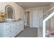 Neutral bedroom featuring white dresser, arched mirror and access to hallway at 13563 E 106Th Pl, Commerce City, CO 80022