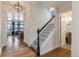 Foyer featuring wood floors, a staircase with white railings, and an open view to the living room at 13563 E 106Th Pl, Commerce City, CO 80022