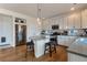 Bright kitchen featuring an island with seating, stainless steel appliances, and abundant counter space at 13563 E 106Th Pl, Commerce City, CO 80022
