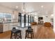 Open-concept floor plan featuring a kitchen island with seating and a living room with ample natural light at 13563 E 106Th Pl, Commerce City, CO 80022