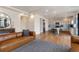 Open concept living room featuring hardwood floors, modern furniture, and seamless access to the kitchen at 13563 E 106Th Pl, Commerce City, CO 80022