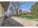 Large backyard with a concrete patio and view of the lawn and trees at 2269 S Yank Ct, Lakewood, CO 80228