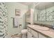 Well-lit bathroom featuring a single sink vanity and white cabinets for storage at 2269 S Yank Ct, Lakewood, CO 80228