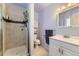 Bathroom with tiled shower, tiled floors, updated vanity, and mirrored medicine cabinet at 2269 S Yank Ct, Lakewood, CO 80228