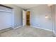Cozy bedroom with a neutral color palette, plush carpet, and a door that leads to another room at 2269 S Yank Ct, Lakewood, CO 80228