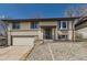 Charming two-story home with a well-manicured lawn and attached garage at 2269 S Yank Ct, Lakewood, CO 80228