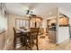 Bright open kitchen with stainless steel appliances, dining area, and hardwood floors at 2269 S Yank Ct, Lakewood, CO 80228