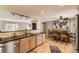Bright kitchen featuring granite countertops and stainless steel appliances with dining area at 2269 S Yank Ct, Lakewood, CO 80228
