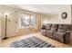 Inviting living room with hardwood floors, bay window, and comfortable seating at 2269 S Yank Ct, Lakewood, CO 80228