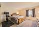 Spacious bedroom features plush carpet, a large window, and a bed with a decorative wooden frame at 2269 S Yank Ct, Lakewood, CO 80228