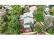 Aerial view of the home showcasing the gray roof, wooded lot and cozy backyard seating at 10718 Ash Ct, Thornton, CO 80233