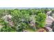 View of home and tree-filled yard with wooden fence providing privacy at 10718 Ash Ct, Thornton, CO 80233