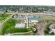 Aerial view showcasing the park's tennis and basketball courts, walking path and landscaped grounds at 10718 Ash Ct, Thornton, CO 80233