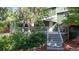 Charming back deck with gray wood and stairs leading to the yard surrounded by bushes and trees at 10718 Ash Ct, Thornton, CO 80233