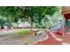 Lush backyard with a stone walkway, picnic table under a shade tree, and staircase to the upper deck at 10718 Ash Ct, Thornton, CO 80233