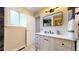 Bathroom with contemporary vanity, black fixtures, neutral walls, and a framed mirror at 10718 Ash Ct, Thornton, CO 80233