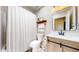 Bathroom featuring wood accents, a framed mirror, shower with curtain, and a toilet at 10718 Ash Ct, Thornton, CO 80233