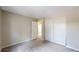 Bedroom with neutral walls, a large closet, carpet, and a doorway to a bathroom at 10718 Ash Ct, Thornton, CO 80233