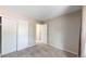 Bedroom with carpet, a closet with sliding doors, and an open doorway to an adjacent room at 10718 Ash Ct, Thornton, CO 80233