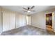 Spacious bedroom with carpet floors, ceiling fan, closets, and en-suite bathroom at 10718 Ash Ct, Thornton, CO 80233