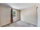 Simple bedroom with neutral walls, plush carpet, and a window with a view of trees at 10718 Ash Ct, Thornton, CO 80233