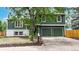 Two-story home featuring an attached garage, lush trees, and well-maintained landscaping at 10718 Ash Ct, Thornton, CO 80233