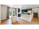 Kitchen and dining room with stainless steel appliances, custom cabinets, and access to outdoor deck at 10718 Ash Ct, Thornton, CO 80233
