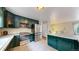Modern kitchen with stainless steel appliances, tile countertops, and ample cabinet space at 10718 Ash Ct, Thornton, CO 80233