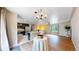 Spacious open concept living room and kitchen with hardwood floors and plenty of natural light at 10718 Ash Ct, Thornton, CO 80233