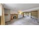 Living room with a fireplace, carpet, sliding door to the patio, and a window at 10718 Ash Ct, Thornton, CO 80233